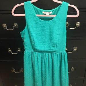 Teal sleeveless dress, fitted waist, flowy bottom